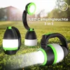 Three LED camping lights are displayed on a grassy surface with a blurred background of trees and sky. Produktbild-Vorschau
