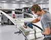 A person is sanding a car door in a workshop. Anteprima dell’immagine prodotto