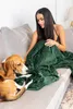 A woman and a dog are on a couch with a blanket. Náhled obrázku produktu