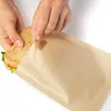 Hands are shown placing a sandwich into a reusable toast bag. Produktbild-Vorschau