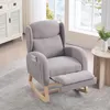 A gray rocking chair with an extended footrest is shown in a well-lit room with a window and a side table. Podgląd zdjęcia produktu