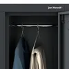 Inside view of a gray locker with two hanging garments on hangers and a name plate on the top inside door. Produktbild-Vorschau