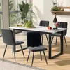 A dining table set with four chairs, a bottle of wine, and fruit on a marble-top table in a dining room. Produktbild-Vorschau