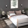A bedroom scene with a bed, nightstands, and artwork. Produktbild-Vorschau