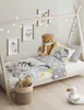 A child's bed with bedding featuring animal prints and decorative lights. Náhled obrázku produktu