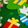 A close-up view of a felt Christmas tree with various felt ornaments attached. Voir les images du produit