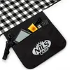 A close-up view of a black pocket on a picnic blanket, showing various items inside. Produktbild-Vorschau
