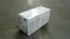 A white cardboard box for a printer toner cartridge is placed on a concrete floor. Produktbild-Vorschau