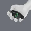 A white mannequin hand holding a black tool with green markings. Anteprima dell’immagine prodotto