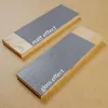 Two wooden planks with gray paint applied, one with a matt finish and the other with a gloss finish, demonstrating different paint effects. Produktbild-Vorschau