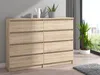 A wooden dresser with eight drawers is shown in a room with a large window. Produktbild-Vorschau