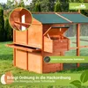 A wooden chicken coop with a green roof, set up in a grassy outdoor area. Produktbild-Vorschau