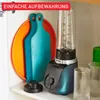 A blender and cutting boards are neatly stored on a shelf in a kitchen cabinet. Anteprima dell’immagine prodotto