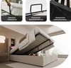A collage of images showing different features of a bed frame, including a hand lift, mattress holder, and hydraulic mechanism, along with a full view of the bed with storage. Produktbild-Vorschau