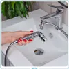 A hand holding a bidet sprayer over a sink. Anteprima dell’immagine prodotto