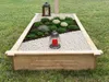 A grave marker frame with plants and lanterns. Produktbild-Vorschau