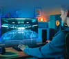 A person playing a video game on a computer with a soundbar in front of the monitor. Voir les images du produit