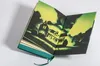 An open book with a spooky illustration of a house on the pages. Produktbild-Vorschau