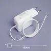 A white Macbook charger with its cable coiled neatly on a light gray surface. Produktbild-Vorschau