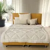 A neatly made bed with a yellow headboard and white bedding, set against a backdrop of sheer white curtains and a large potted plant. Produktbild-Vorschau