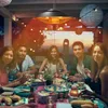 A group of people are enjoying a meal outdoors at dusk, with string lights and a hanging heater providing ambiance. Náhled obrázku produktu