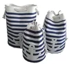 Three nautical-themed laundry bags with blue and white stripes and anchor emblems, arranged on a white background. Produktbild-Vorschau