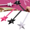 Three star-shaped wand-like salt and pepper shakers in pink, black, and white are arranged on a white background, with a blurred background showing food on a plate and a hand sprinkling spices. Náhľad obrázku produktu