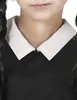 Close-up of a child wearing a black dress with a white collar. Produktbild-Vorschau