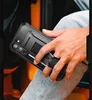 A person holding a black phone case with a kickstand and ring holder. Produktbild-Vorschau