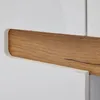 A close-up view of a piece of furniture, showing a white surface meeting a wooden insert. Voir les images du produit