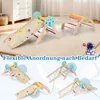 A wooden indoor climbing structure for children, shown in various configurations with colorful accents and climbing holds. The image also includes a small cartoon astronaut figure. Voir les images du produit