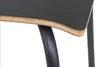 A close-up view of the edge of a black conference chair seat, showing the layered plywood construction and a curved metal leg. Produktbild-Vorschau