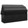 A black outdoor lounge bed with a roof and cushions, covered by a black protective cover. Produktbild-Vorschau
