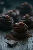 Close-up of chocolate truffles on a wooden surface. Produktbild-Vorschau