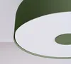 A close-up, angled view of a green ceiling lamp with a white diffuser. Produktbild-Vorschau