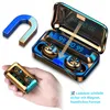 A hand holding a charging case for wireless earbuds, with a horseshoe magnet and an open charging case with earbuds inside shown in the background. Produktbild-Vorschau