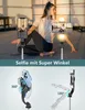 A woman is doing yoga while being filmed by two selfie sticks with lights. Náhľad obrázku produktu