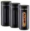 Three black storage jars with clear windows, one filled with pasta. Produktbild-Vorschau