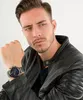A man wearing a leather jacket and a watch. Voir les images du produit