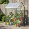 A small greenhouse filled with potted plants, set up on a wooden deck. Podgląd zdjęcia produktu