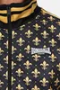 Close-up of a black and gold patterned jacket with a Lonsdale London logo. Náhled obrázku produktu