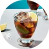 A close-up of a glass of cola with ice and lime. Produktbild-Vorschau