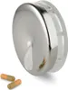 A pillbox with two pills in front of it, on a white background. Produktbild-Vorschau