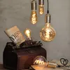 A collection of vintage-style light bulbs and a leather bag with a rolled-up document. Podgląd zdjęcia produktu