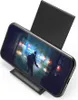 A black wireless charger with a smartphone displaying a video game. Anteprima dell’immagine prodotto