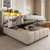 A bedroom scene featuring a bed with its storage compartment open, revealing stored items and a mattress. Produktbild-Vorschau