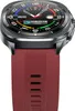 A close-up shot of a smartwatch with a red strap against a white background. Náhled obrázku produktu