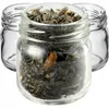 Three small glass jars, one filled with dried tea leaves and the other two empty. Podgląd zdjęcia produktu