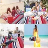 Collage of four images showing people using a striped picnic blanket in various settings: on a beach, camping, indoors, and at the beach again. Podgląd zdjęcia produktu