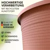 A close-up of a terracotta-colored plant pot with text overlays highlighting its features and origin. Produktbild-Vorschau